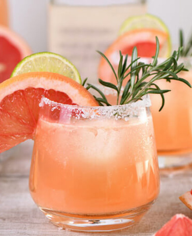 glass of paloma with fruit garnish