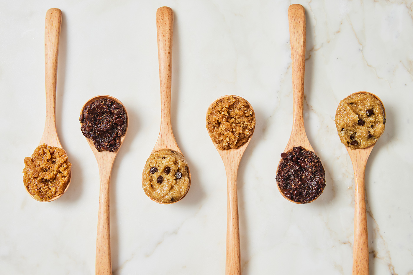 Various Wooden Spoons Full of Doughy