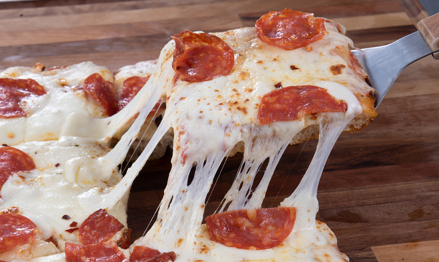 pizza slice with cheese tendrils