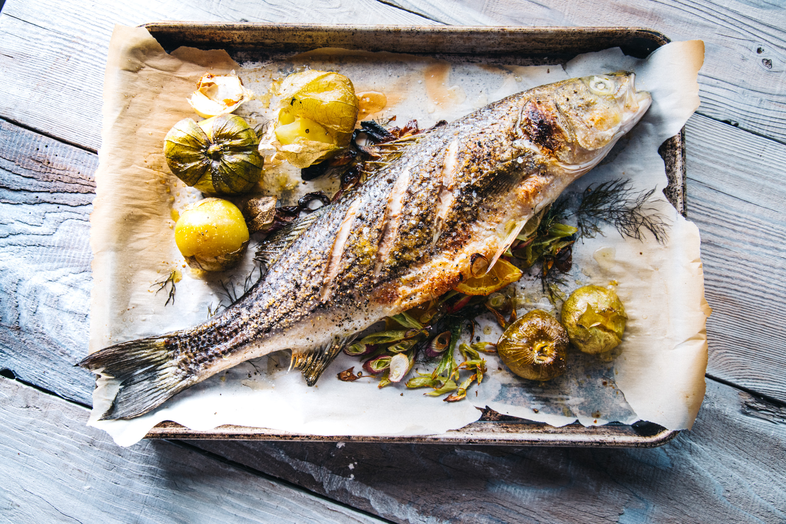 whole fish on platter with potatoes