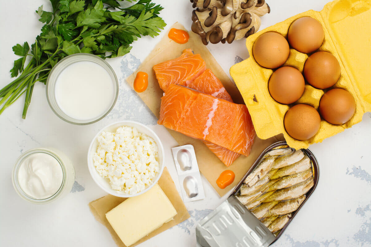 salmon, cheese, sardines, eggs, mushrooms, and parsley on a table