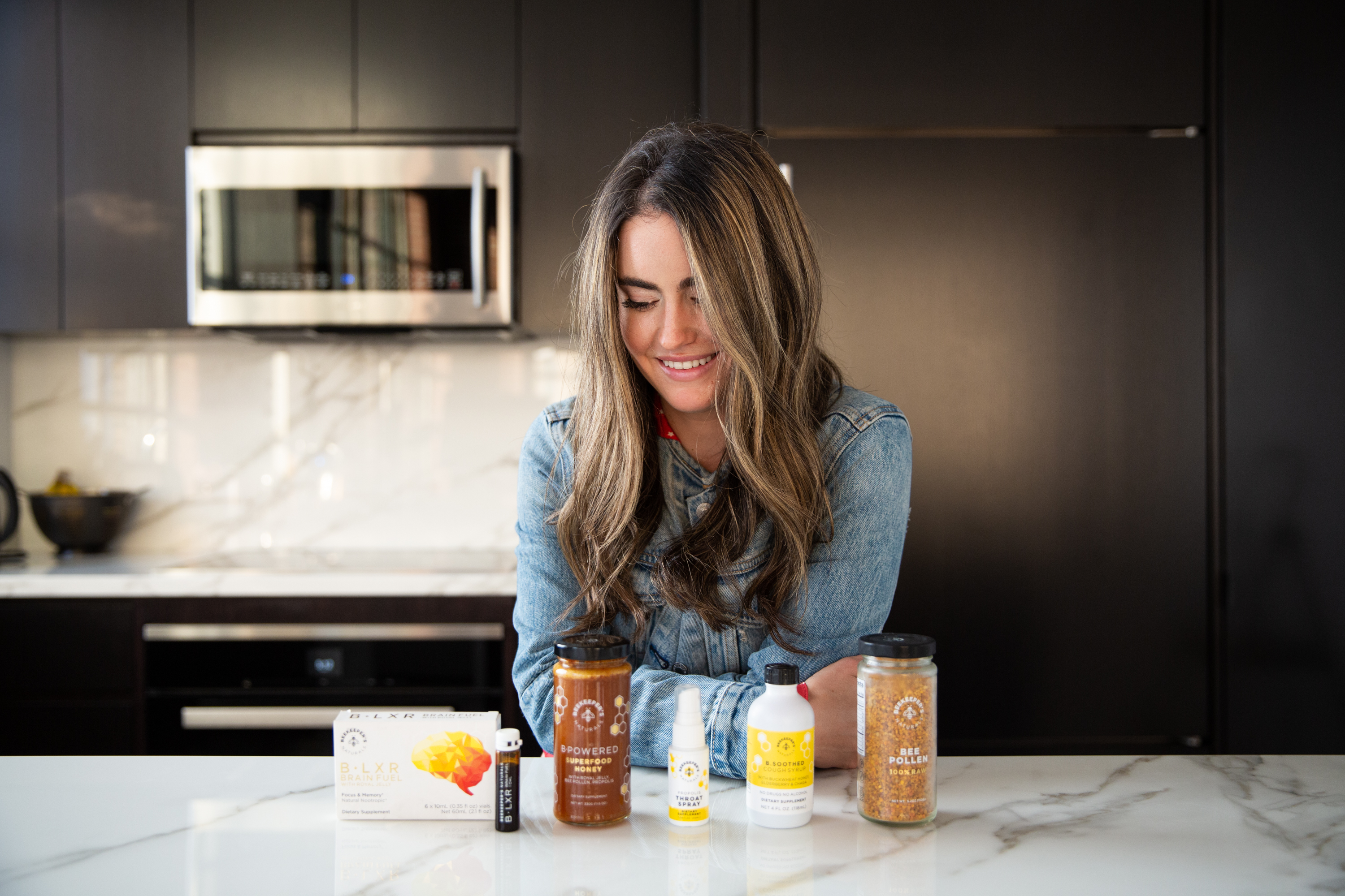 Carly looking at an array of Beekeeper's products 