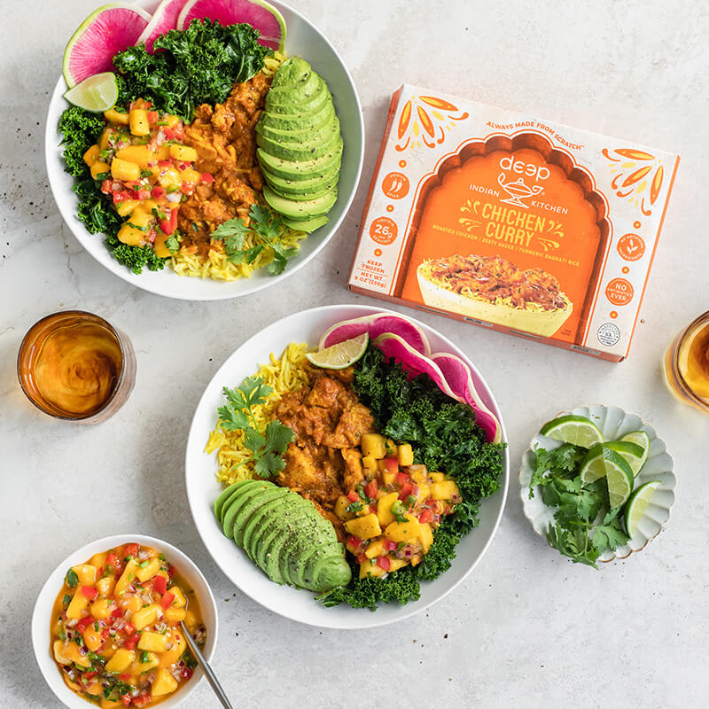 Bowls of chicken curry with toppings