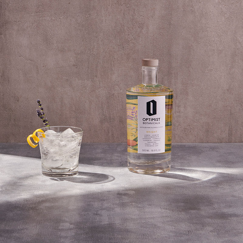 Bottle and glass of Optimist Botanicals drink