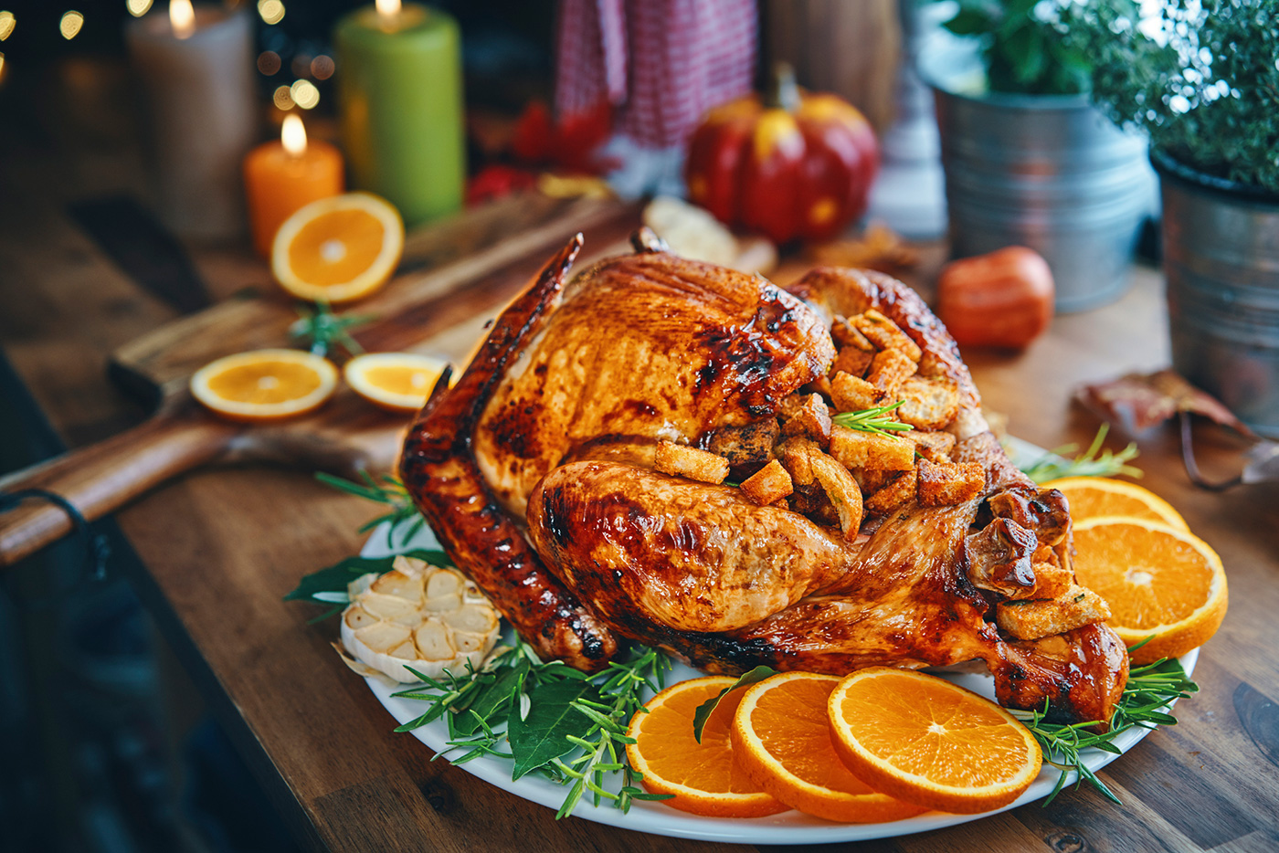 cooked turkey served on platter with orange slices