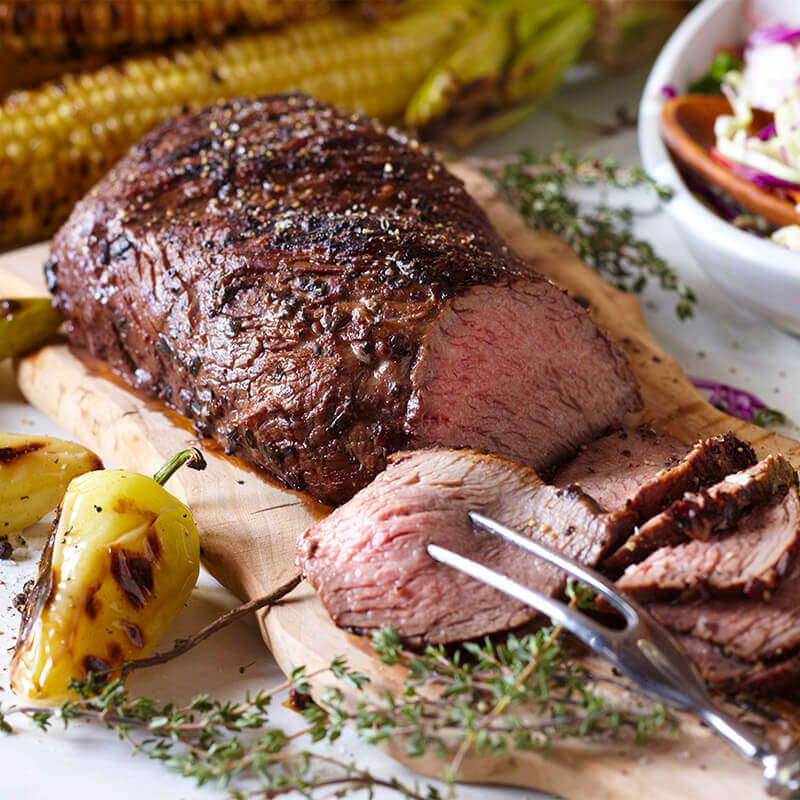 Sliced tri-tip on a board