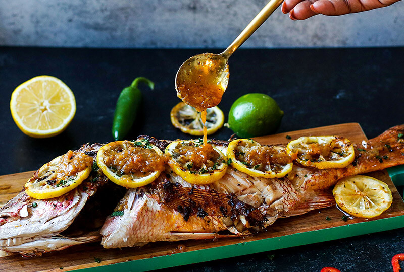 Fish covered in lemons and sauce