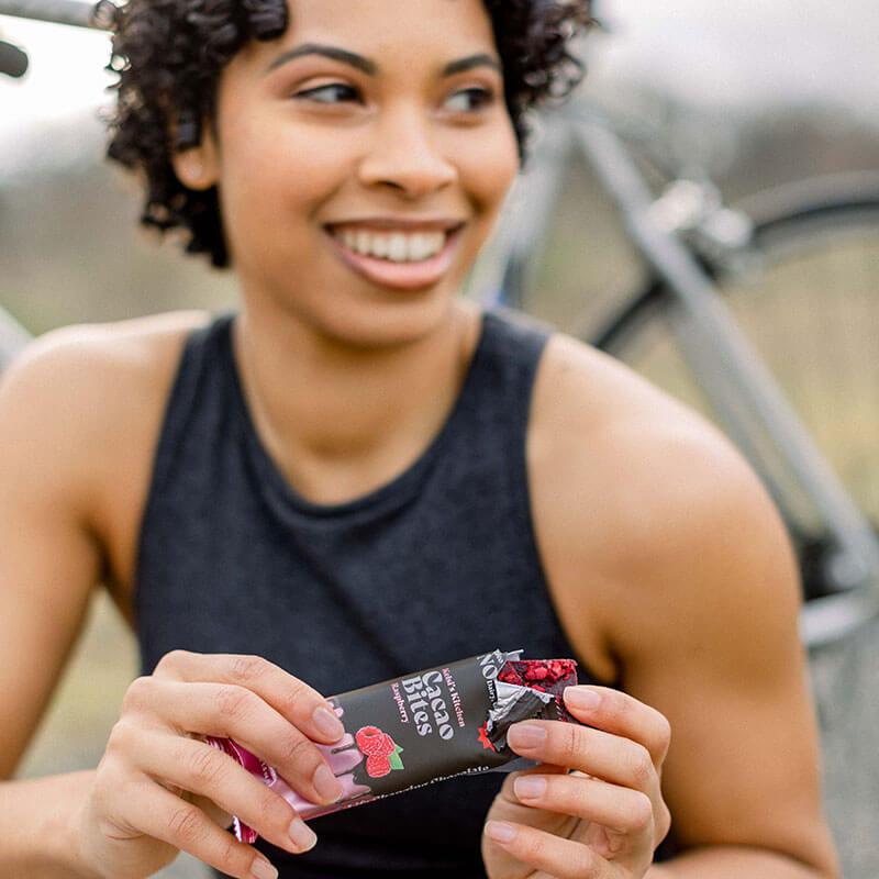 Woman unwrapping raspberry cacao bites